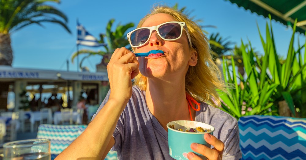 Woman enjoying ice cream outside on a sunny day